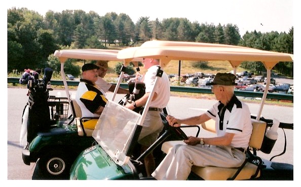Ernie in golf cart talking to Joe Kempfer